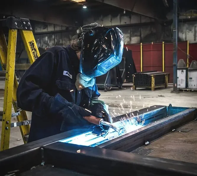 women welding garbage truck parts for wastebuilt